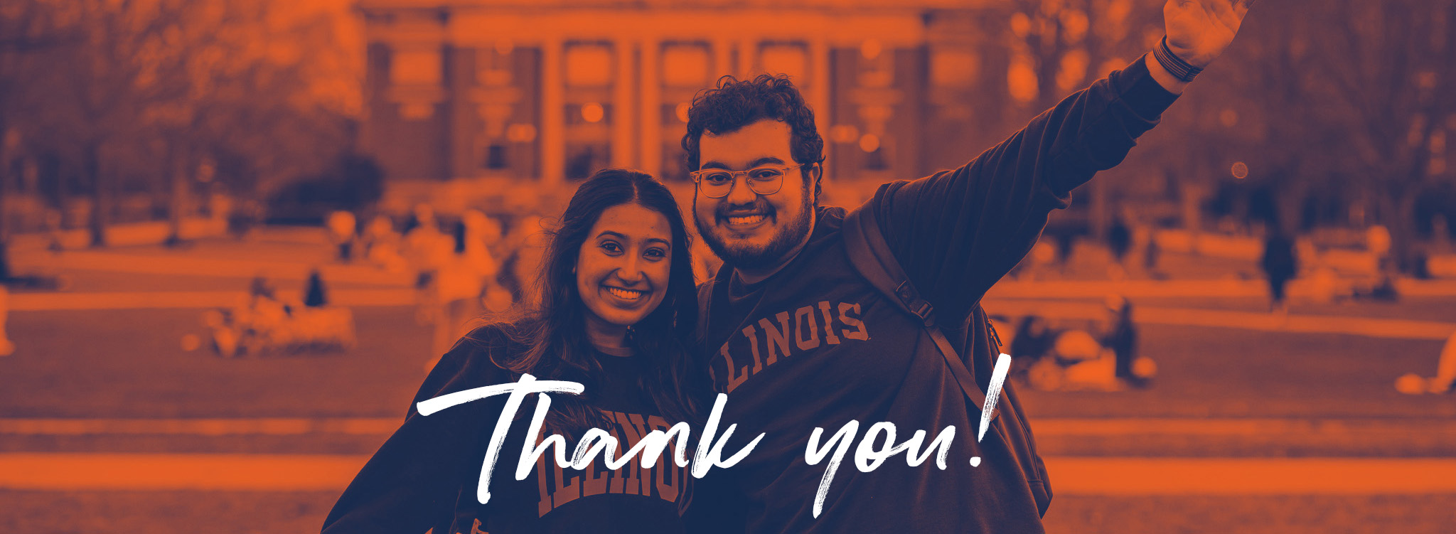 Thank You in cursive script with a picture of two students waving